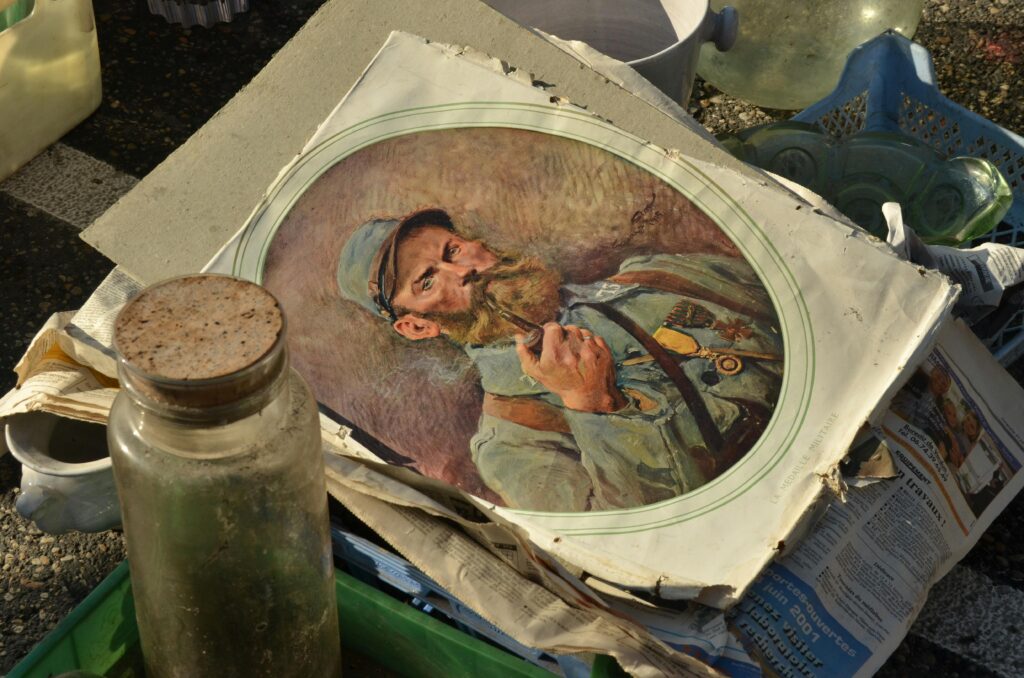 An artistic antique painting found at an outdoor market, featuring a man with a pipe.